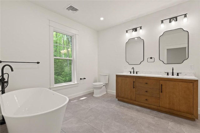 66 Orchard Ave, Johnston, RI 02919 - bathroom with double vanity, a freestanding tub, and recessed lighting