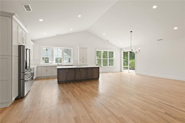 66 Orchard Ave, Johnston, RI 02919 - kitchen featuring a chandelier, a kitchen island, lofted ceiling, light countertops, and open floor plan