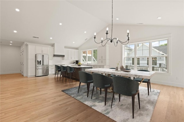 66 Orchard Ave, Johnston, RI 02919 - dining space with a chandelier, high vaulted ceiling, light wood-style flooring, and recessed lighting