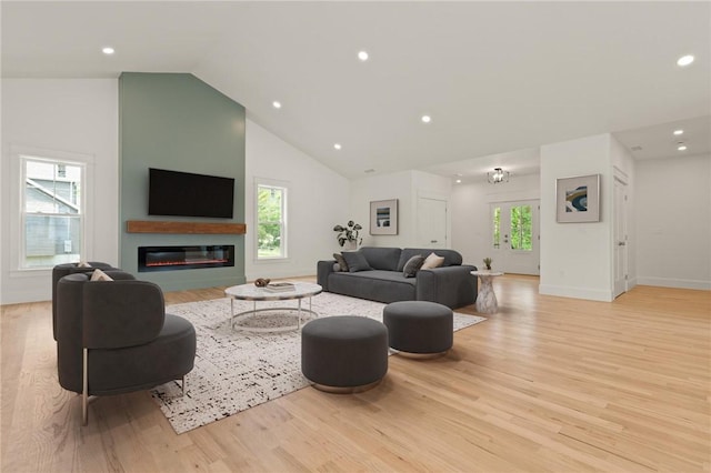 66 Orchard Ave, Johnston, RI 02919 - living room with light wood finished floors, recessed lighting, a glass covered fireplace, and high vaulted ceiling