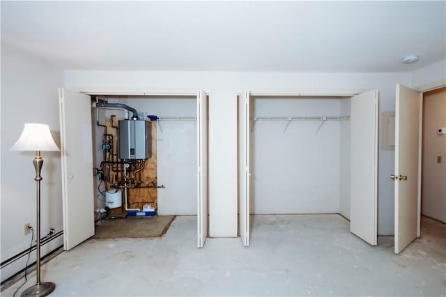66 Girard Ave Unit 106, Newport, RI 02840 - unfurnished bedroom with baseboard heating, water heater, concrete floors, and multiple closets