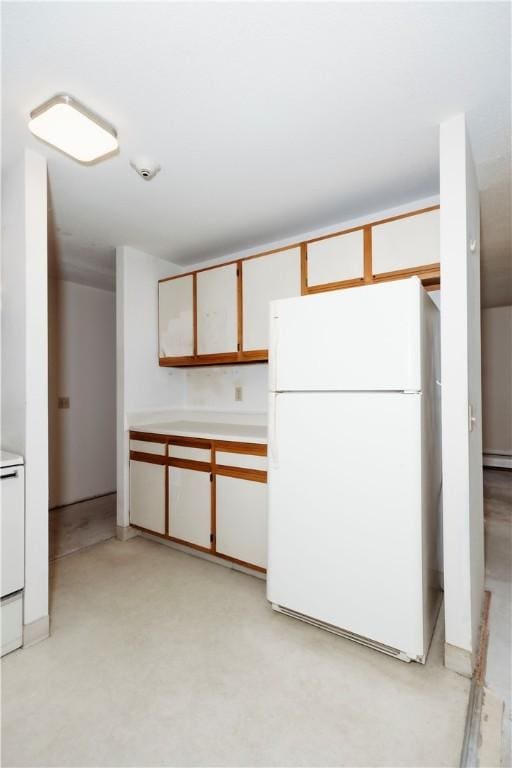 66 Girard Ave Unit 106, Newport, RI 02840 - kitchen featuring freestanding refrigerator, light countertops, and baseboard heating