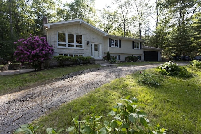 38 Williams Rd, Smithfield, RI 02917 - bi-level home featuring a chimney, dirt driveway, and a garage