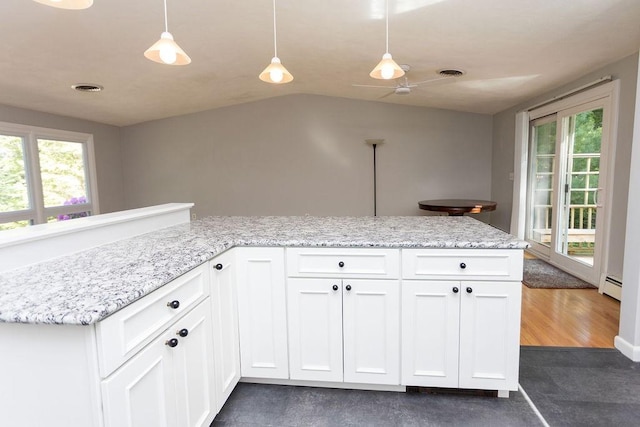 38 Williams Rd, Smithfield, RI 02917 - kitchen with baseboard heating, white cabinetry, hanging light fixtures, light stone countertops, and vaulted ceiling