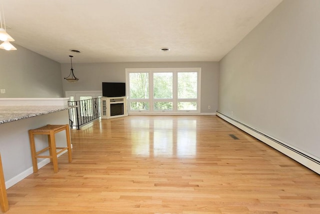 38 Williams Rd, Smithfield, RI 02917 - unfurnished living room featuring a baseboard radiator, light wood-style floors, and baseboards