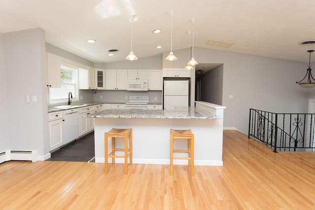 38 Williams Rd, Smithfield, RI 02917 - kitchen with white appliances, light wood-style flooring, white cabinetry, a breakfast bar, and vaulted ceiling