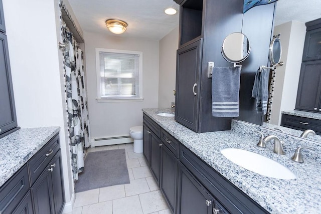 38 Williams Rd, Smithfield, RI 02917 - full bathroom with a baseboard radiator, double vanity, toilet, and tile patterned floors