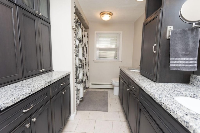 38 Williams Rd, Smithfield, RI 02917 - bathroom featuring a baseboard radiator, toilet, double vanity, and tile patterned flooring