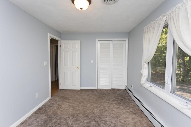 38 Williams Rd, Smithfield, RI 02917 - unfurnished bedroom featuring a baseboard heating unit, carpet, a closet, and baseboards