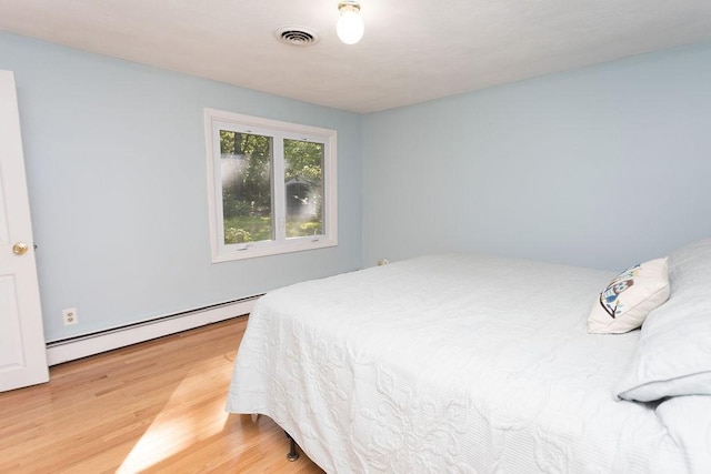 38 Williams Rd, Smithfield, RI 02917 - bedroom featuring a baseboard heating unit and light wood-style flooring
