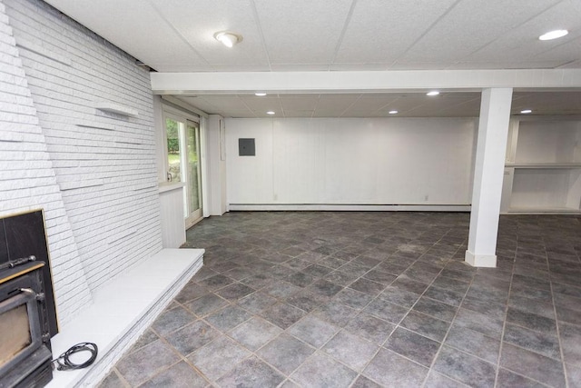 38 Williams Rd, Smithfield, RI 02917 - basement with baseboard heating, brick wall, electric panel, recessed lighting, and a wood stove