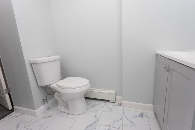 38 Williams Rd, Smithfield, RI 02917 - half bath featuring baseboard heating, toilet, marble look tile flooring, baseboards, and vanity