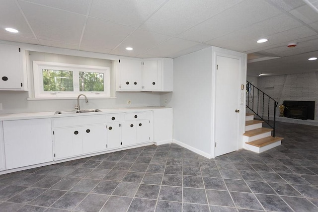 38 Williams Rd, Smithfield, RI 02917 - kitchen with a sink, a paneled ceiling, white cabinets, baseboards, and light countertops