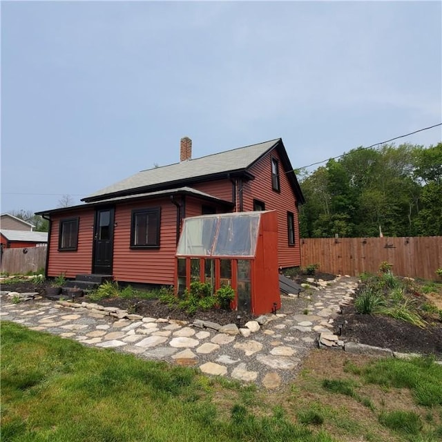 199 Plainfield Pike, Scituate, RI 02857 - rear view of house featuring a chimney