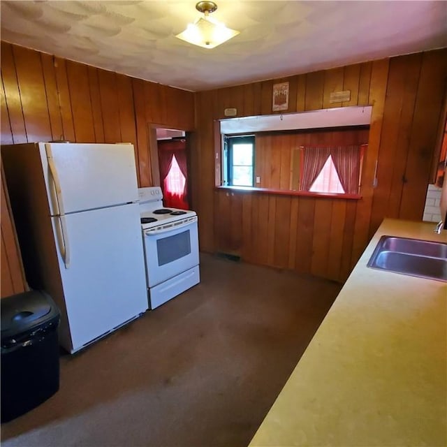 199 Plainfield Pike, Scituate, RI 02857 - kitchen featuring white appliances, a sink, wood walls, carpet, and light countertops