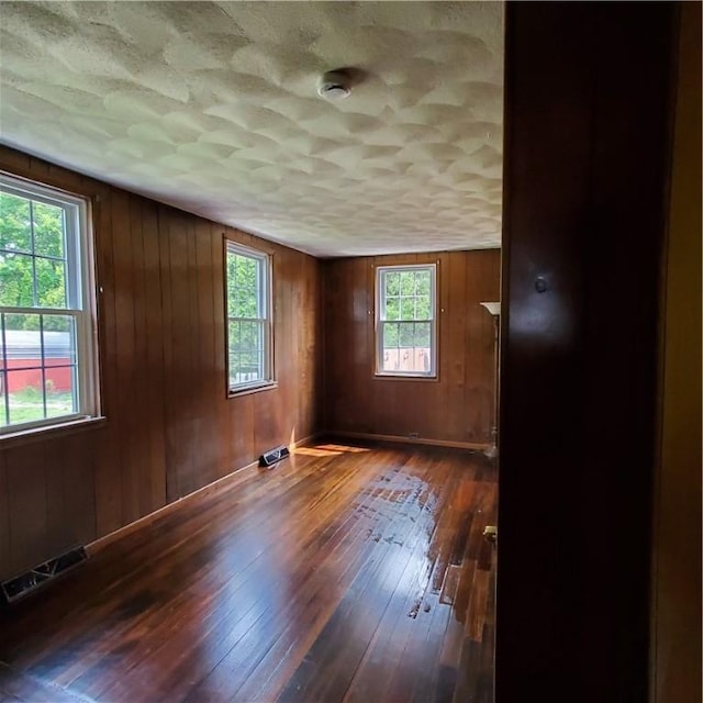 199 Plainfield Pike, Scituate, RI 02857 - spare room with hardwood / wood-style flooring, a smoke detector, a textured ceiling, and wooden walls