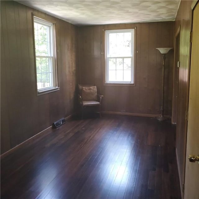 199 Plainfield Pike, Scituate, RI 02857 - unfurnished room featuring dark wood-type flooring, wood walls, and baseboards