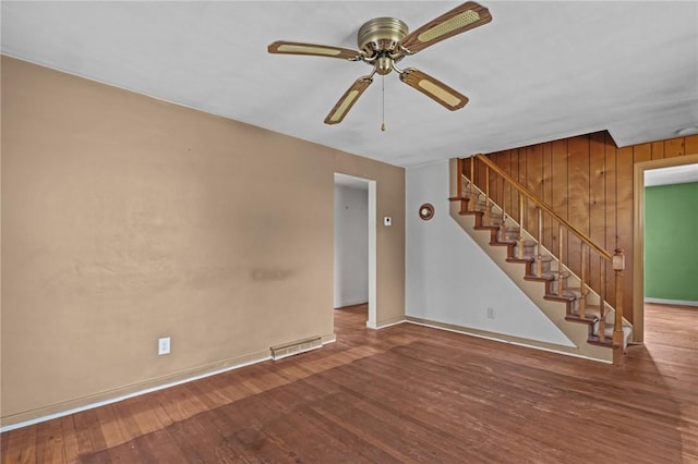 16 King Rd, Middletown, RI 02842 - unfurnished living room featuring ceiling fan, stairway, wood finished floors, and baseboards