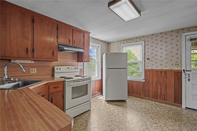16 King Rd, Middletown, RI 02842 - kitchen featuring freestanding refrigerator, white range with electric stovetop, a sink, under cabinet range hood, and a wainscoted wall