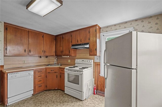16 King Rd, Middletown, RI 02842 - kitchen featuring white appliances, under cabinet range hood, a sink, light countertops, and light flooring