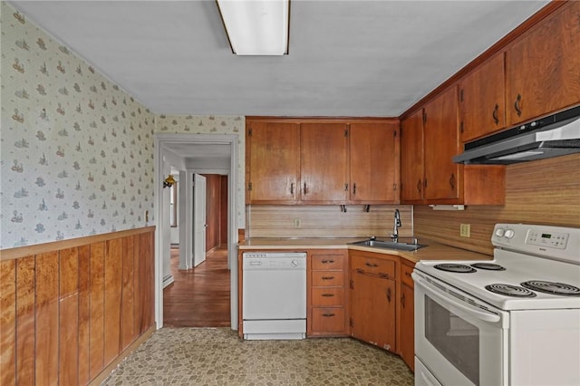 16 King Rd, Middletown, RI 02842 - kitchen featuring white appliances, a sink, wallpapered walls, under cabinet range hood, and a wainscoted wall