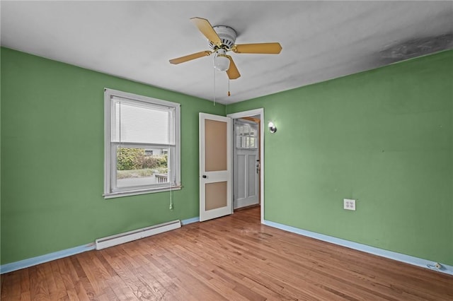 16 King Rd, Middletown, RI 02842 - unfurnished room with a baseboard heating unit, baseboards, a ceiling fan, and wood finished floors