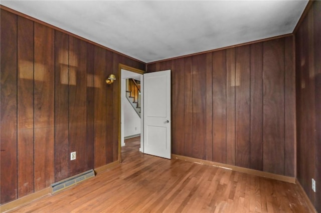 16 King Rd, Middletown, RI 02842 - spare room with wooden walls, wood finished floors, stairs, and baseboards