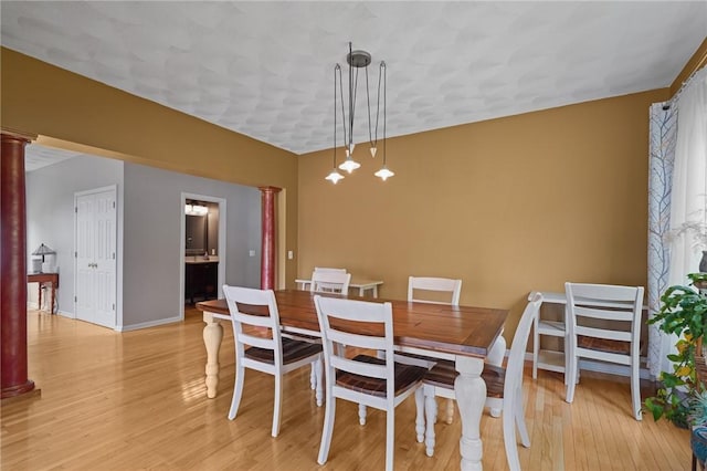 510 Westmoreland Ln, North Kingstown, RI 02874 - dining room featuring ornate columns, light wood-type flooring, and baseboards