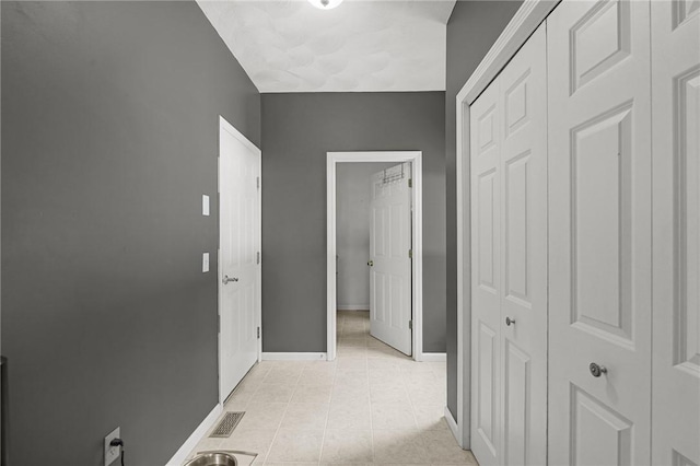 510 Westmoreland Ln, North Kingstown, RI 02874 - hall with baseboards and light tile patterned floors