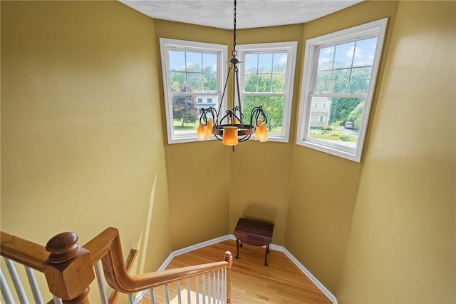 510 Westmoreland Ln, North Kingstown, RI 02874 - staircase with healthy amount of natural light, baseboards, wood finished floors, and a chandelier