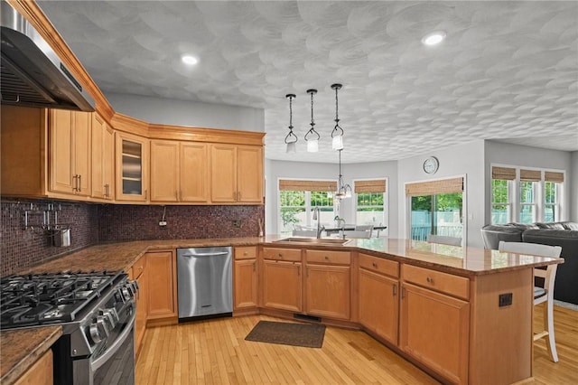 510 Westmoreland Ln, North Kingstown, RI 02874 - kitchen featuring appliances with stainless steel finishes, a sink, range hood, a peninsula, and glass insert cabinets