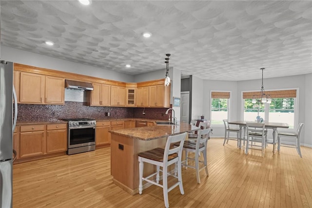 510 Westmoreland Ln, North Kingstown, RI 02874 - kitchen with appliances with stainless steel finishes, wall chimney exhaust hood, a sink, a breakfast bar, and glass insert cabinets