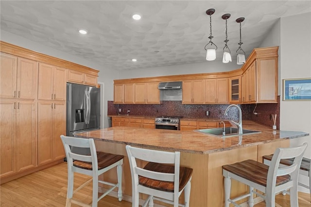 510 Westmoreland Ln, North Kingstown, RI 02874 - kitchen featuring appliances with stainless steel finishes, range hood, a sink, a peninsula, and tasteful backsplash