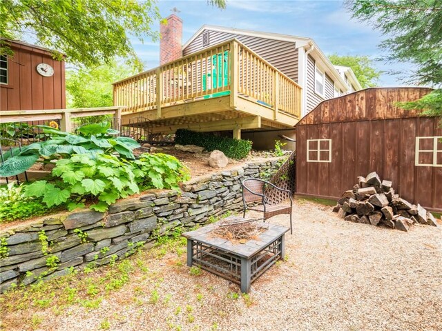 860 Centerville Rd, Warwick, RI 02886 - back of house with an outdoor fire pit, a wooden deck, and a chimney