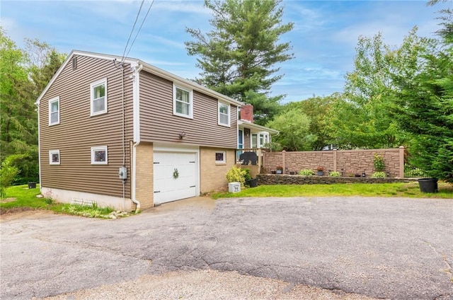 860 Centerville Rd, Warwick, RI 02886 - view of front of house with driveway, a garage, and brick siding