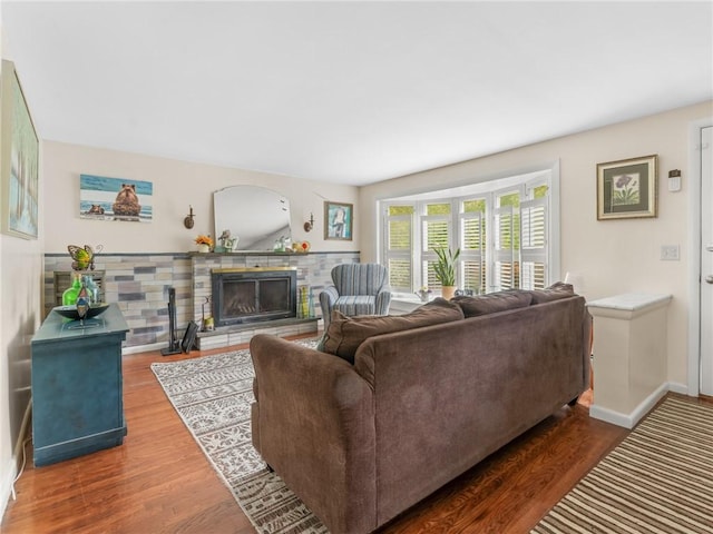 860 Centerville Rd, Warwick, RI 02886 - living area featuring a fireplace with raised hearth, wood finished floors, and baseboards