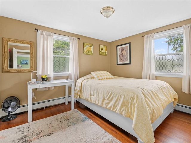 860 Centerville Rd, Warwick, RI 02886 - bedroom with wood finished floors and a baseboard heating unit