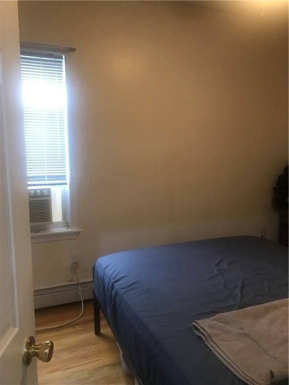 72 Mercy St, Providence, RI 02909 - bedroom with a baseboard heating unit and light wood-style floors