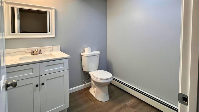 106 Leigh Rd, Cumberland, RI 02864 - bathroom featuring a baseboard radiator, toilet, vanity, wood finished floors, and baseboards