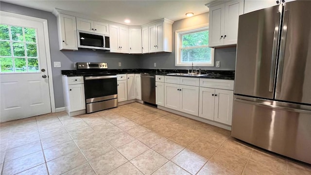 106 Leigh Rd, Cumberland, RI 02864 - kitchen featuring appliances with stainless steel finishes, a sink, recessed lighting, light tile patterned floors, and white cabinetry