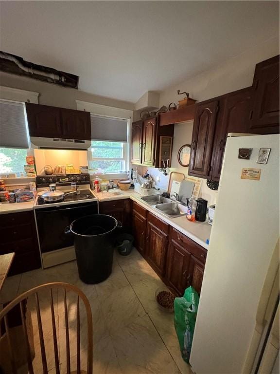 202 Jenckes St, Woonsocket, RI 02895 - kitchen featuring a sink, freestanding refrigerator, light countertops, dark brown cabinets, and under cabinet range hood