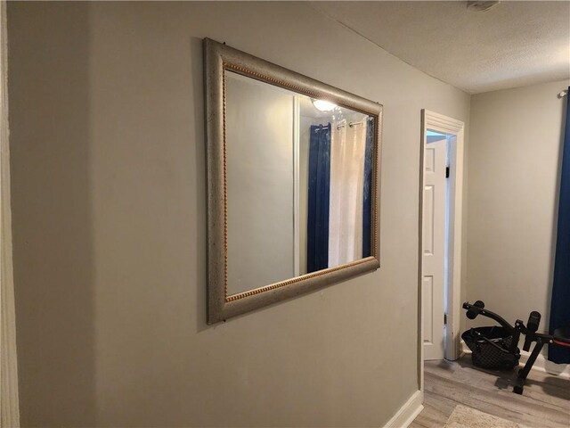 27 Unit St, Providence, RI 02909 - corridor with wood finished floors, baseboards, and a textured ceiling