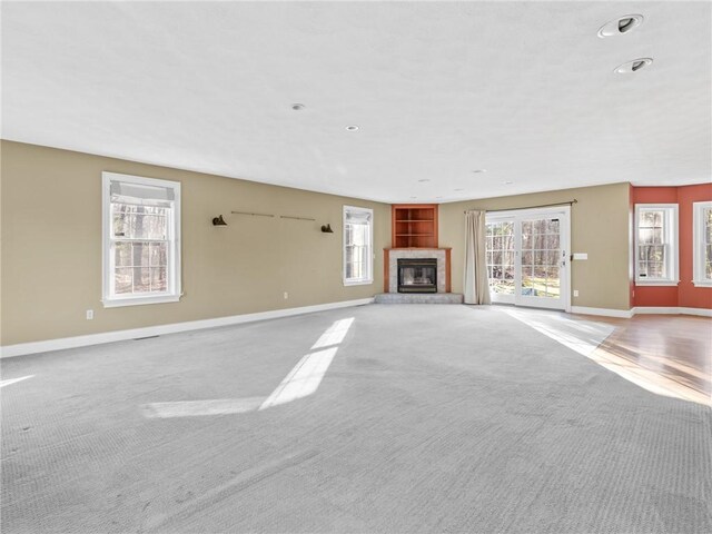 44 Azalea Ave, Exeter, RI 02822 - unfurnished living room with carpet flooring, baseboards, a glass covered fireplace, and recessed lighting