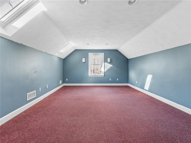 44 Azalea Ave, Exeter, RI 02822 - additional living space with dark colored carpet, lofted ceiling, baseboards, and a skylight