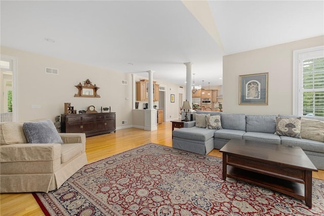 43 Kayla Ricci Way, Exeter, RI 02874 - living area with ornate columns and light wood-style flooring