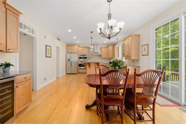 43 Kayla Ricci Way, Exeter, RI 02874 - dining area featuring beverage cooler, a chandelier, light wood-style floors, recessed lighting, and baseboards