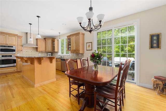 43 Kayla Ricci Way, Exeter, RI 02874 - dining room featuring light wood-style flooring, a chandelier, and baseboards