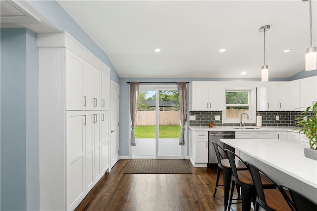 149 Weeden Dr, Warwick, RI 02818 - kitchen featuring dishwasher, a sink, healthy amount of natural light, a breakfast bar area, and recessed lighting