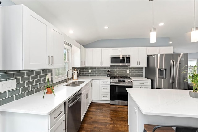 149 Weeden Dr, Warwick, RI 02818 - kitchen with stainless steel appliances, a sink, tasteful backsplash, vaulted ceiling, and white cabinets