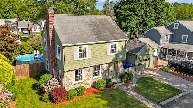 44 Felsmere Ave, Pawtucket, RI 02861 - colonial home featuring stone siding, a chimney, driveway, an attached garage, and a shingled roof